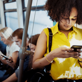 Woman looking at her phone on public transport